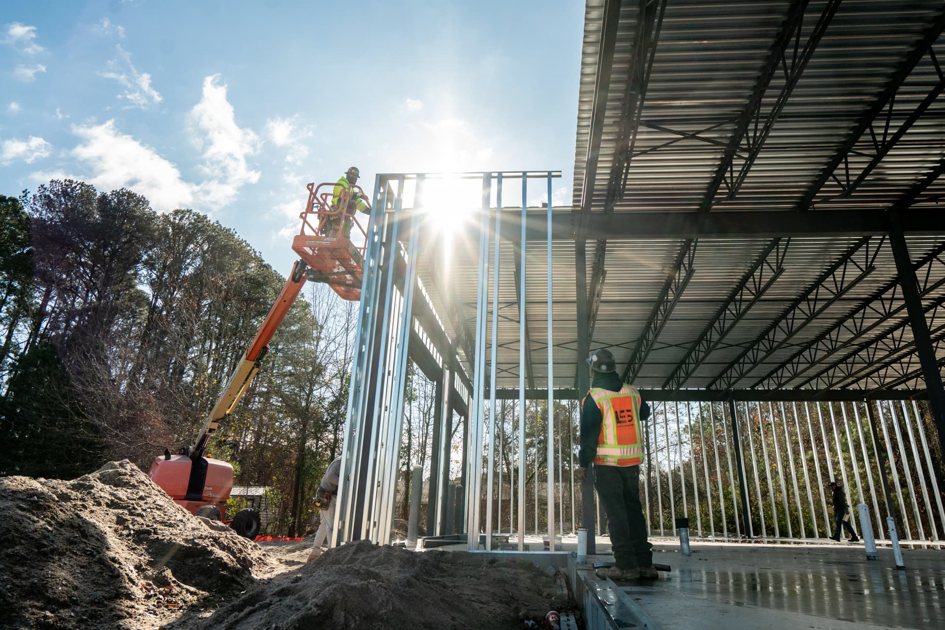 LCS crew erecting structural steel framing on a sunlit commercial job site