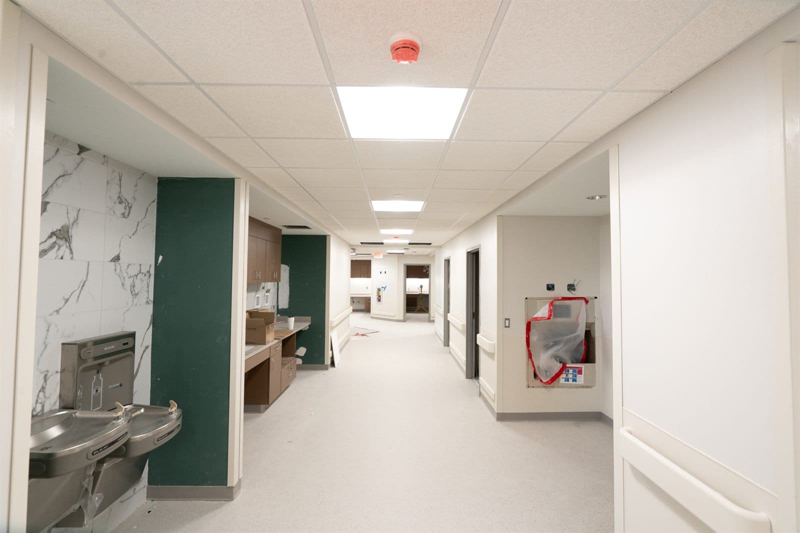 Finished commercial drywall corridor reading flat and clean under even lighting