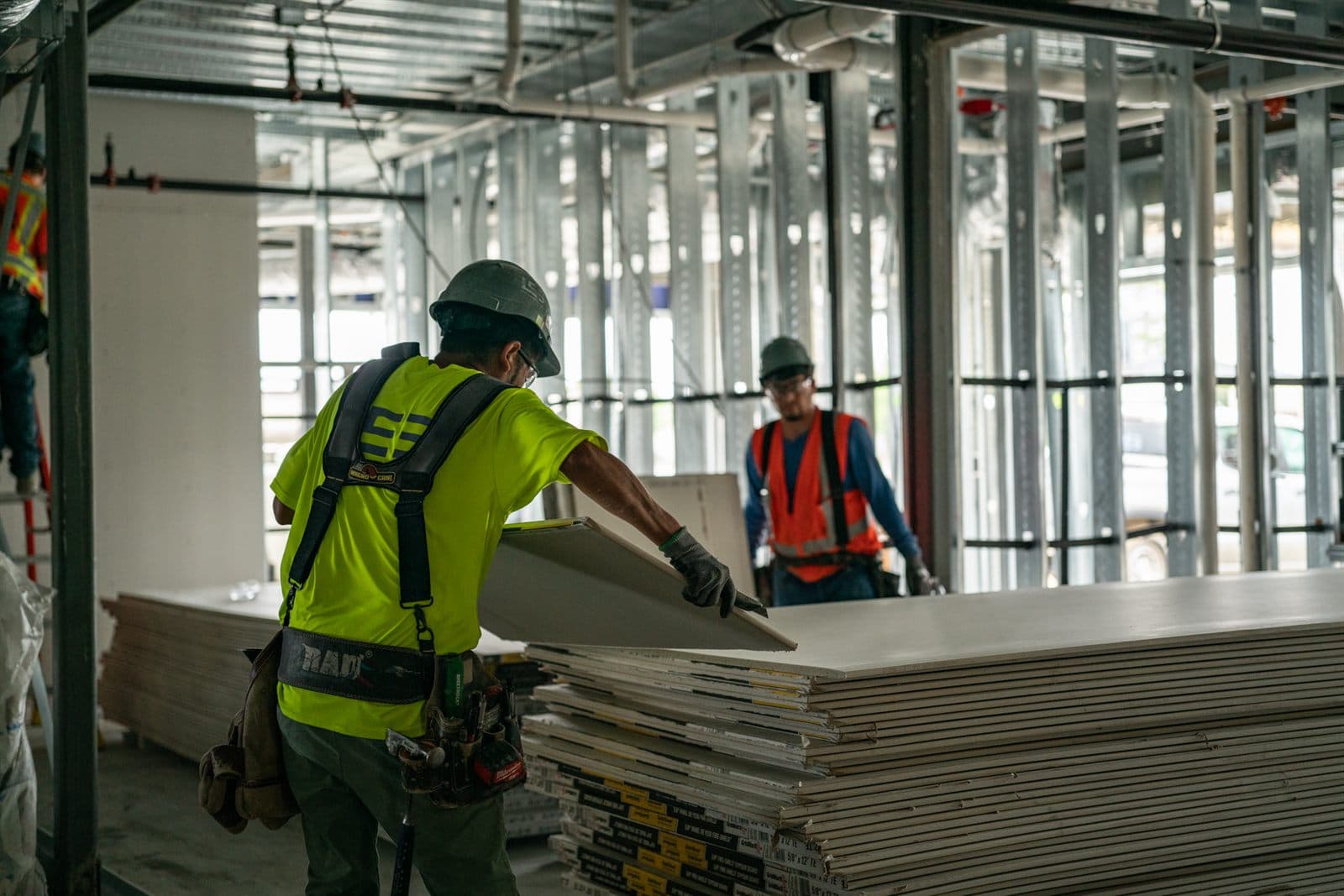 LCS crew hanging gypsum board on a commercial job site