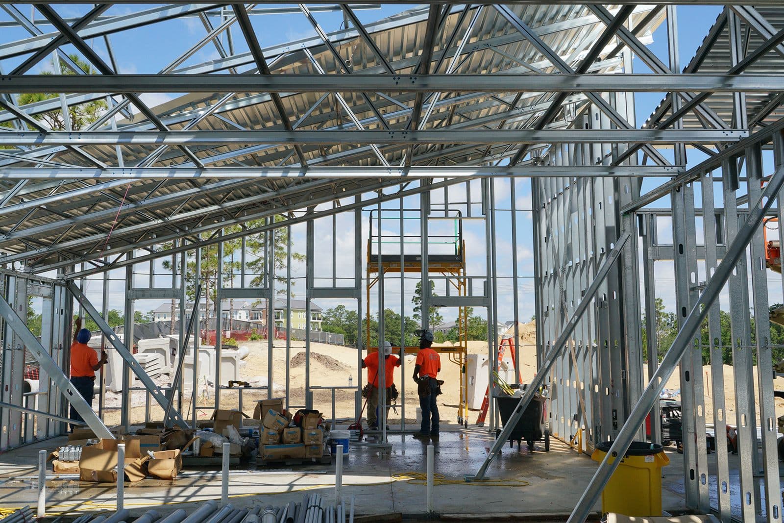 LCS crew working inside a structural light-gauge steel framing system on a commercial build