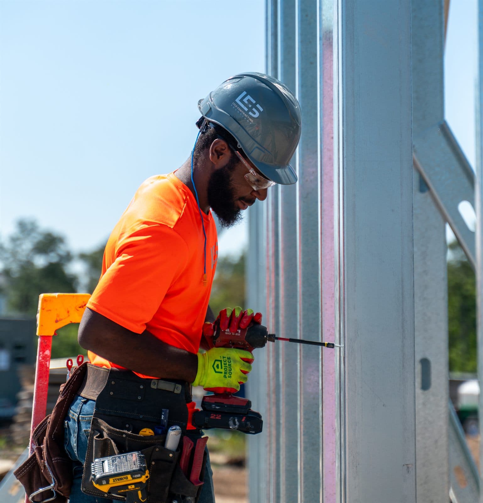 LCS framer installing an exterior light-gauge steel stud wall on a commercial job site