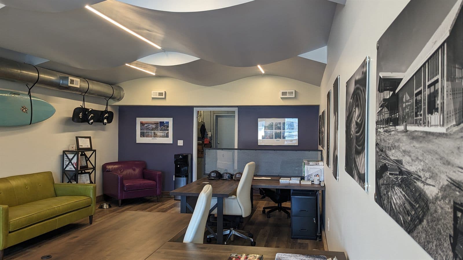 Interior of a Lyle Contracting Solutions office with framed job-site photography on the walls